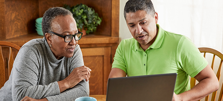 Man and woman working on a laptop